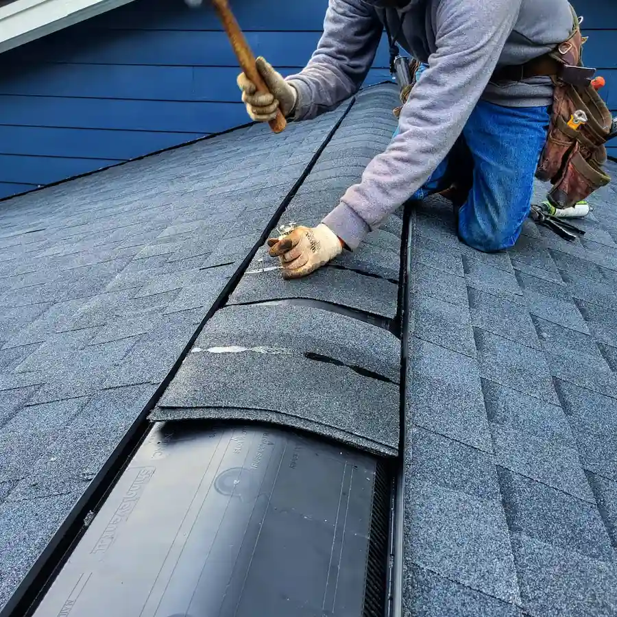 The Importance of Having Filtered Ridge Vent Instead of Unfiltered Ridge Vent 2 Roofing contractor installing filtered ridge vent system on residential roof