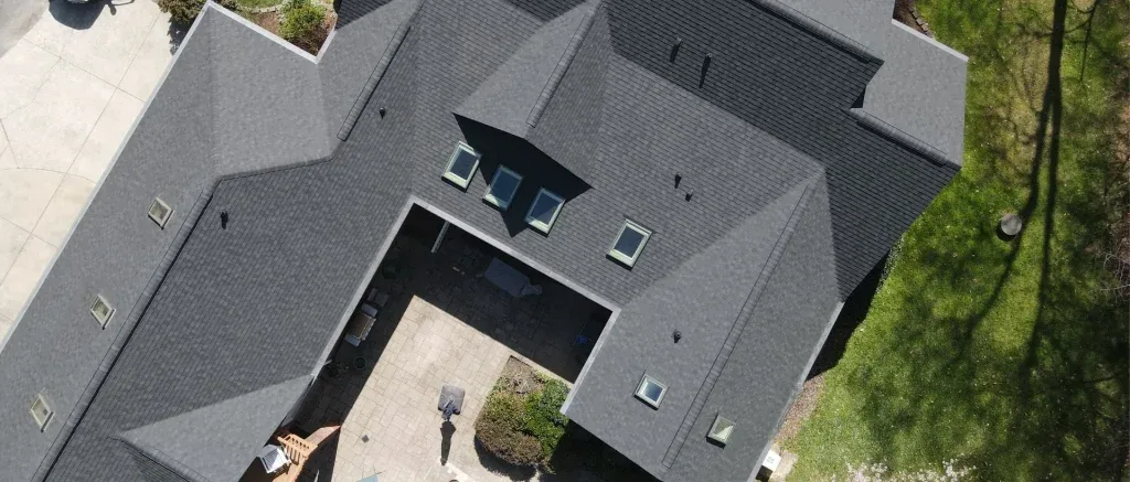Roof flashing installed around skylights on asphalt shingle roof during roof replacement